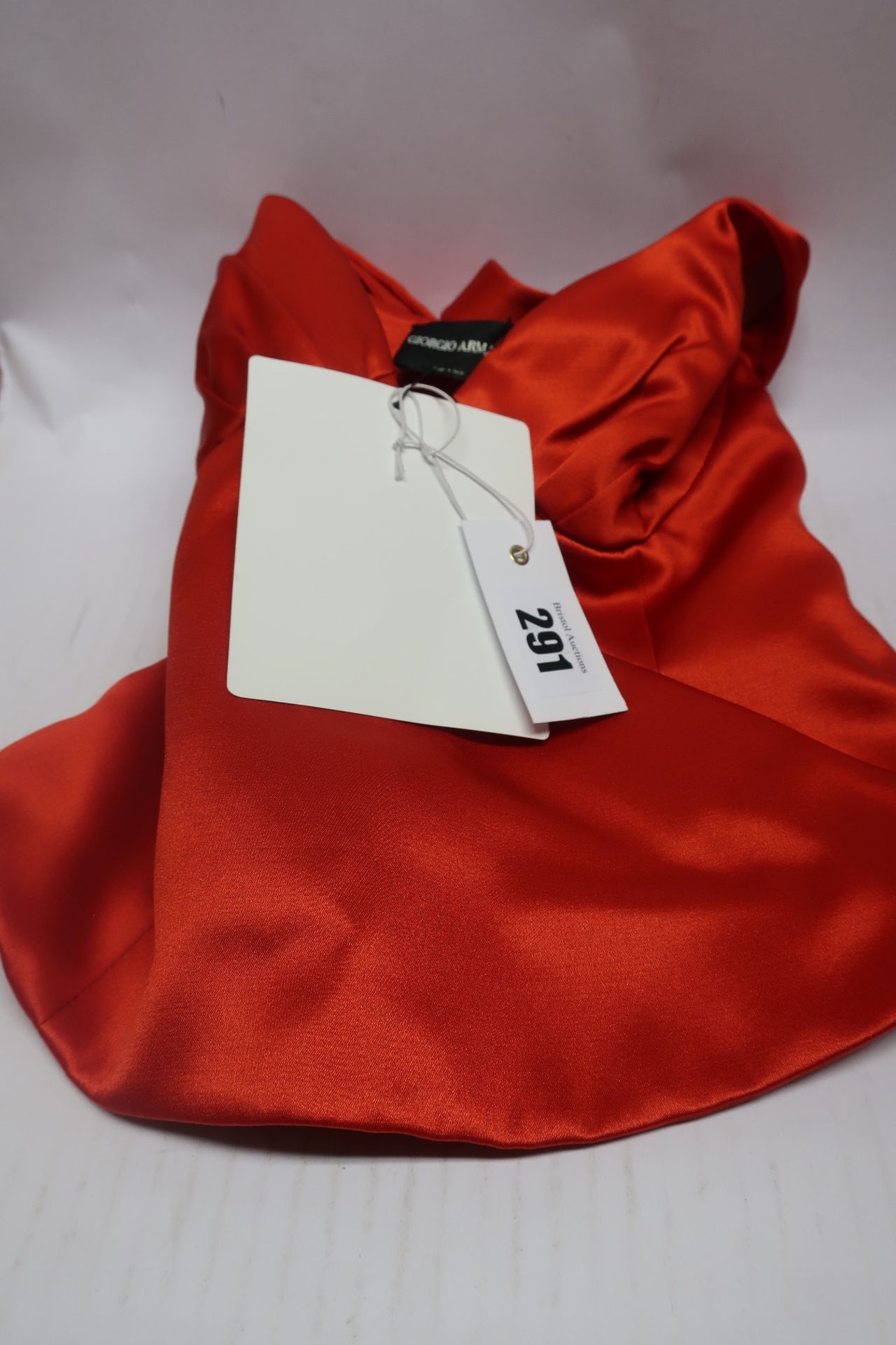 A Giorgio Armani red top (Size unknown).
