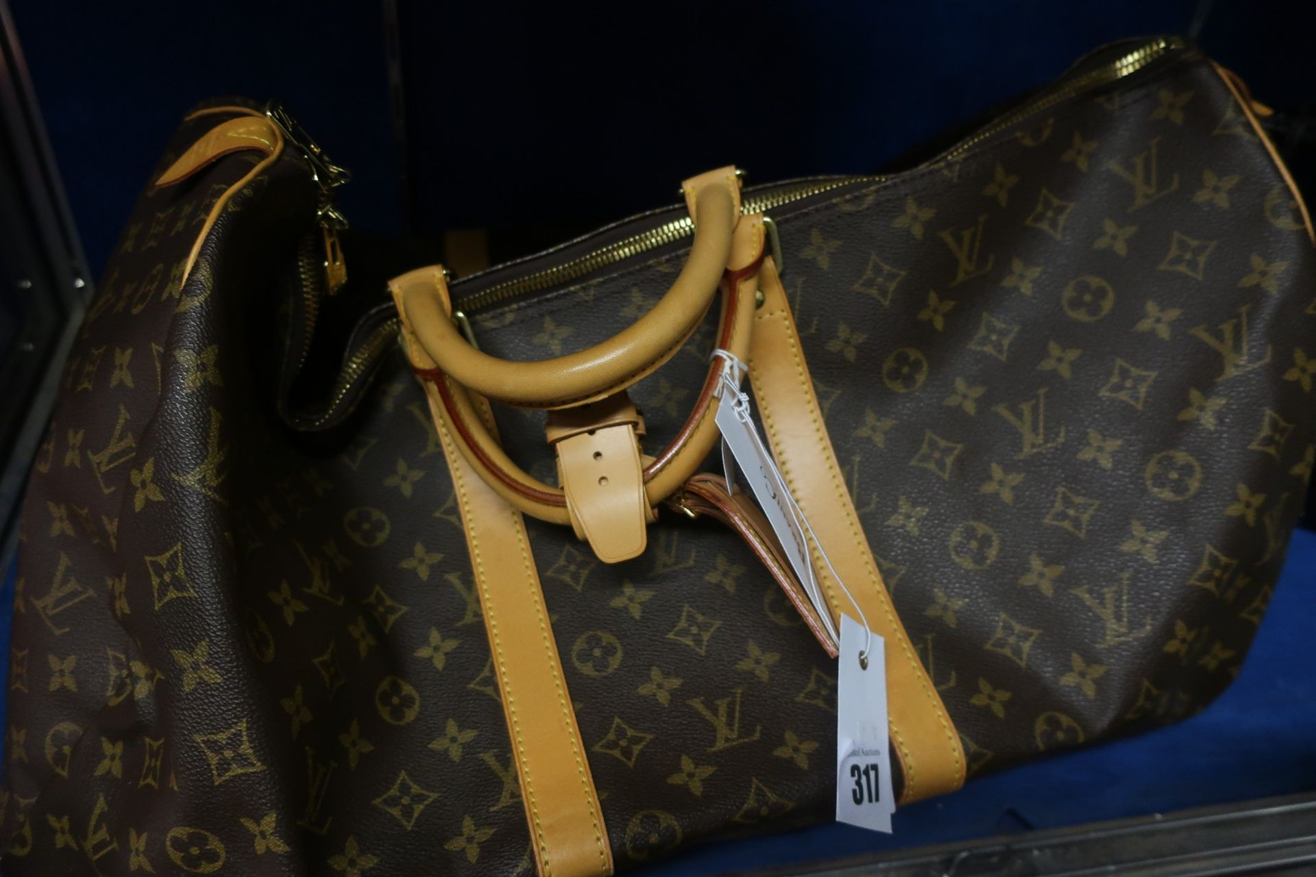 A pre-owned Louis Vuitton brown/gold holdall (Excellent condition).