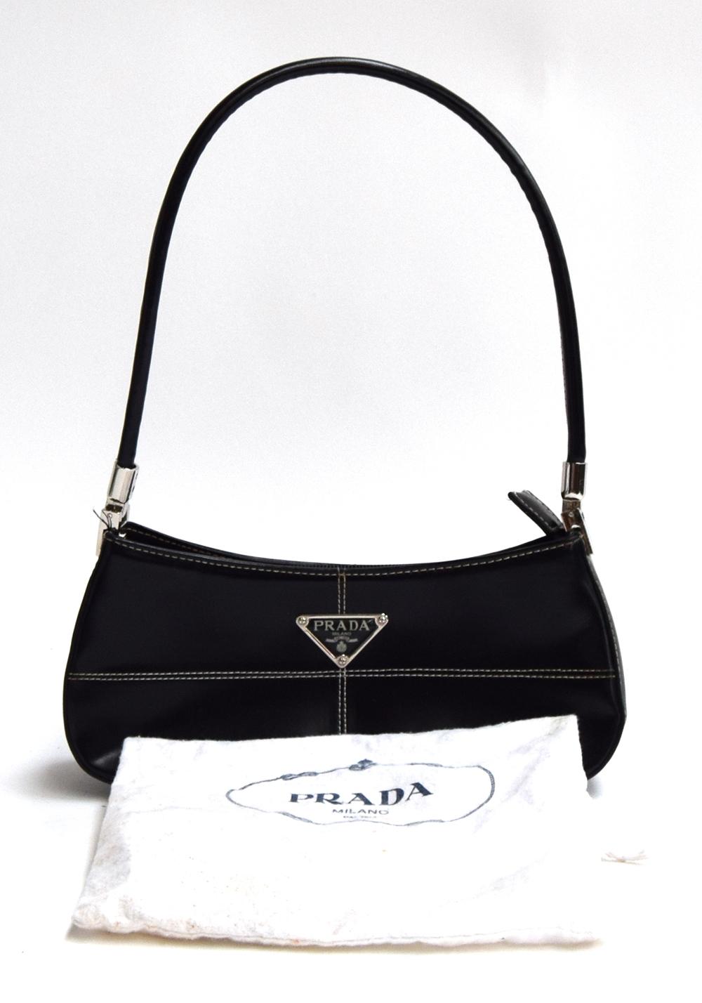 Small firm black leather handbag from Prada with hinged silver hardware holding the handle, very - Image 2 of 2