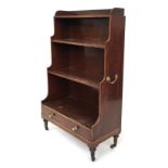 A fine mahogany waterfall open bookcase, the gallery top above four stepped shelves and drawer