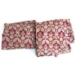 A pair of curtains made from heavy pink and silver damask