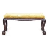 A George III style rectangular mahogany duet stool, the knees with blind fretwork decoration on claw