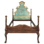 A 19th century Italian green painted pine and parcel gilt bedstead, with rococo headboard and
