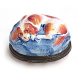 A Bilston enamel oval bonbonnière c.1770, modelled as a red and white spaniel seated on a blue