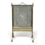 A sliding fire screen, with applied brass putto and stands of musical instruments, each support with