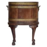 A George III mahogany and brass bound oval wine cooler on later stand with cabriole supports