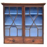 An astragal glazed bookcase, dentil cornice above, with two drawers