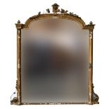 A Regency gilt framed overmantle mirror flanked by beeded moulding and fluted columns, the shaped