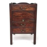 A George III mahogany bedside cabinet, the full gallery top with pierced hand holds above a