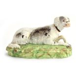 A Staffordshire figure of a seated long dog, 16cmL