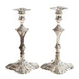 A pair of George III silver candlesticks by Thomas Hannam & John Crouch, London 1764, on squared