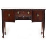 A George III style mahogany serpentine sideboard, fitted with a short frieze drawer and two panelled