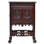 A 19th century Henri II style oak pot cupboard fitted with a single panel door, the legs united by