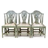 A set of six George III green painted dining chairs, each with slip in seat and pierced splat, on