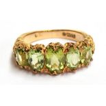 A 9ct gold dress ring set with 5 peridots, size L, 4.2 gross weight