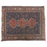 A north-west Persian rug, the indigo field scattered with depictions flora and fauna, with three