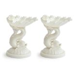 A pair of Royal Worcester shell sweetmeat dishes in white, supported on the tail of a dolphin, shape