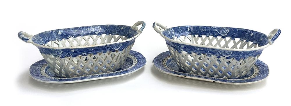 A pair of English blue and white china pierced chestnut baskets of oblong form with twin scroll