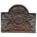 A heavy cast iron fire back of rectangular and stepped arch form, with armorial shield with crown