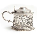 A Victorian silver lidded mustard pot, by John James Keith, London 1841, with leafy scroll pierced