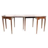 A Regency mahogany D end dining table raised on square tapered legs, with two leaves