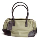 Canvas and leather bowling bag from Prada with leather handles and elbows, zipped closure and