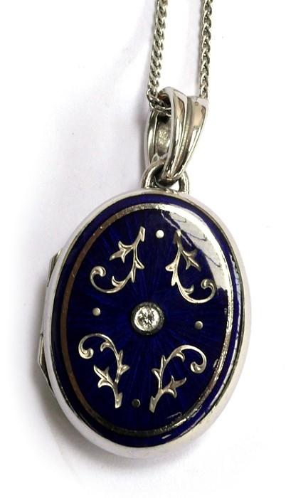 A modern FABERGE 18ct locket (stamped 750) with blue enamel decoration & central diamond set with