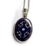 A modern FABERGE 18ct locket (stamped 750) with blue enamel decoration & central diamond set with