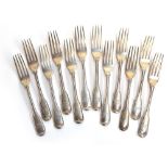 A set of 12 Victorian silver crested fiddle and thread pattern table forks, 11 by George Adams,