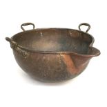 A very large 19th century copper kettle of hemispherical form, with three brass handles and spout,