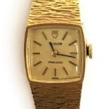 A LADIES 9CT GOLD TUDOR PRECISION BRACELET WATCH CIRCA 1970, gold coloured textured dial, baton