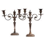 A pair of silver plated two arm candelabra, the central finial removing to reveal a third candle