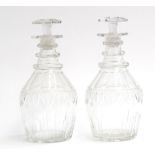 A pair of Georgian style glass decanters and stoppers, the mallet shaped body engraved, triple