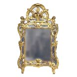 A late 18th century Continental carved giltwood wall mirror, the rectangular central plates