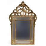A 19th century Italian giltwood wall mirror, the square plate with mirrored border and surmounted by