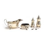 Two silver salts, a silver sugar bowl on three hoof feet, marks rubbed, and a silver sauce boat on