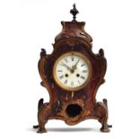 A Louis XV style tortoiseshell veneered mantel clock of cartouche form, the dial with Roman