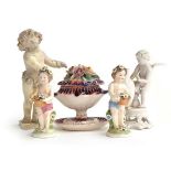 A group of ceramic figures to include a putto with crown impressed to base, 14cmH; another decorated