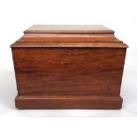 A Georgian satinwood sarcophagus shaped trunk or box, blue lining paper, on small brass casters,