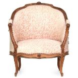 A 19th century Louis XV style carved beech bergere, on cabriole legs covered in pink and white