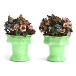 A pair of late 19th century ceramic flower arrangements in green glass vases, 20cmH Provenance: from