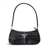 Small firm black leather handbag from Prada with hinged silver hardware holding the handle, very