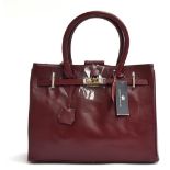 Brand new oxblood leather handbag from Joshua Taylor, padlock closure and key in leather sheath (