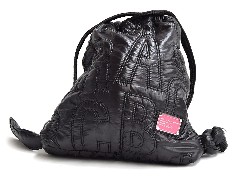 Black nylon backpack from Marc Jacobs, quilted with the letters of the brand, bright pink interior