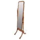 A mahogany veneer cheval mirror, the supported with turned finials, 160cmH