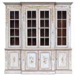 A painted pine breakfront bookcase with four glazed doors above and four panelled doors, decorated