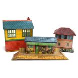 Three vintage tinplate buildings