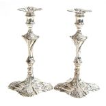 A pair of George III silver candlesticks by Thomas Hannam & John Crouch, London 1765, on squared