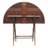 A late 19th century mahogany coaching table, of typical folding construction, opening to a