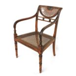 A Regency style open arm chair with painted decoration, with cane seat and demilune back